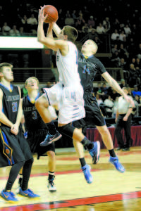 PROTECTING THE LANE â€” Lake Region defenders Quinn Piland (left), Tyler Walker and Marcus DeVoe try to stop Yarmouth's Cody Cook's drive to the basket. (Rivet Photo)